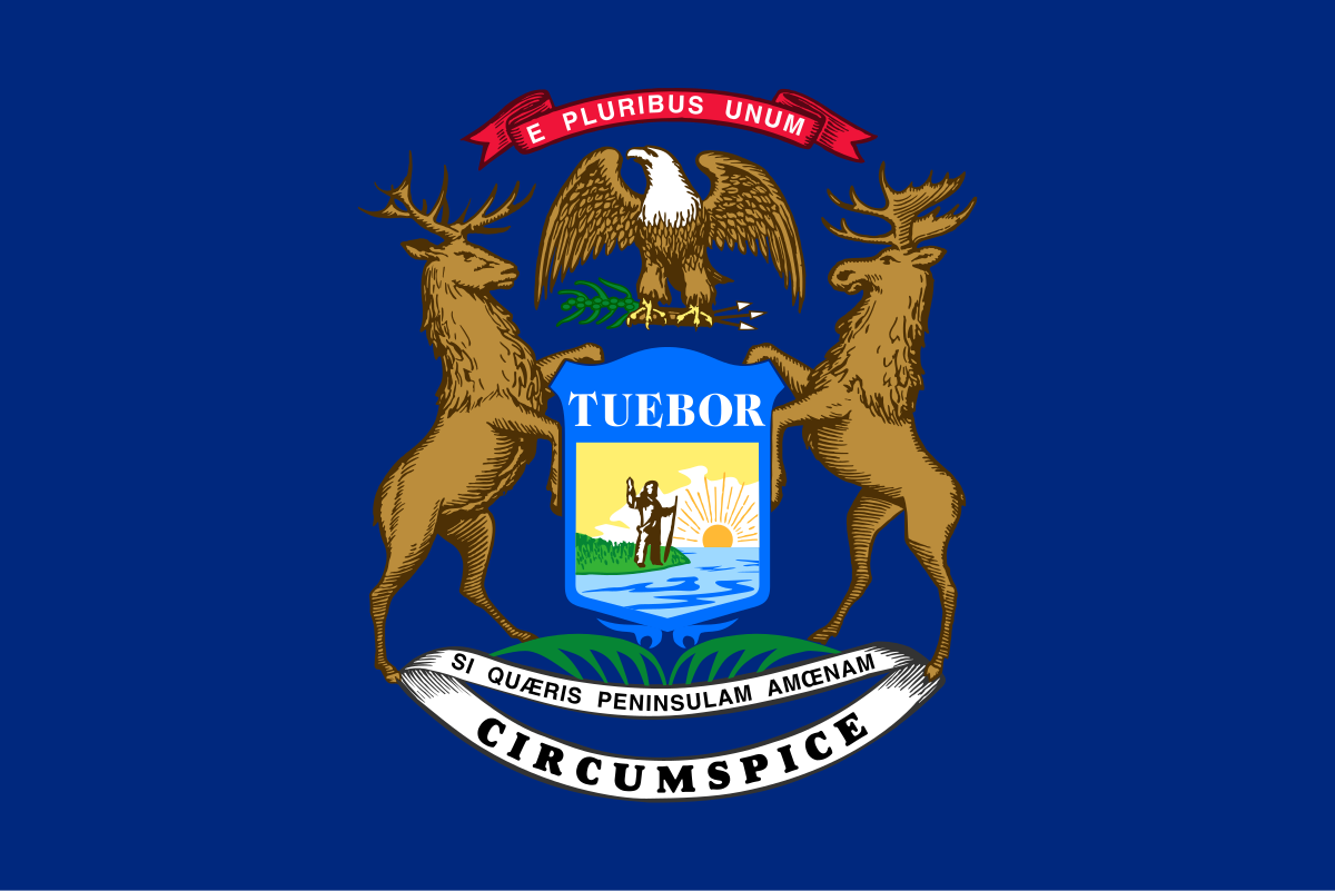 The state flag of Michigan: a blue field with the state's coat of arms in the center. The coat of arms includes a shield with a sun rising over a lake and peninsula, a man holding a rifle and making a gesture of peace, and a bald eagle, elk, and moose.